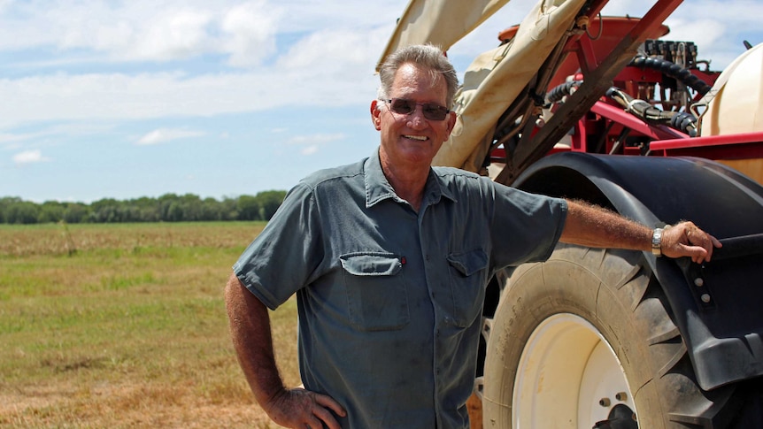 a man leaning against a tyre