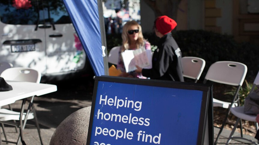 'Helping homeless people find accommodation' written on a NSW family and community services sign