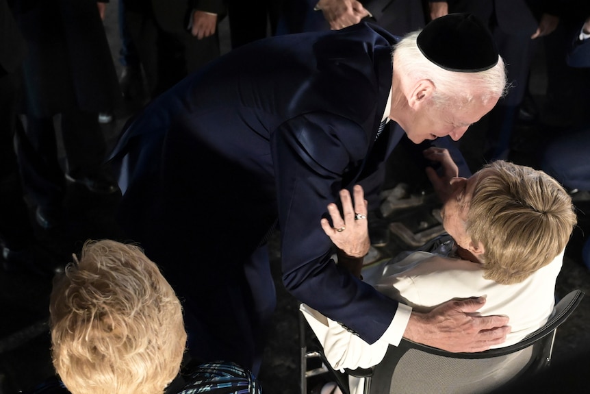 President Joe Biden greets Holocaust survivors with a hug.