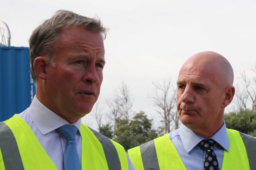 Premier Will Hodgman and Treasurer Peter Gutwein in safety vests.