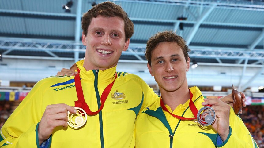 Australia's Thomas Fraser-Holmes (L) and Cameron McEvoy with their gold and silver medals in the men's 200m freestyle in Glasgow