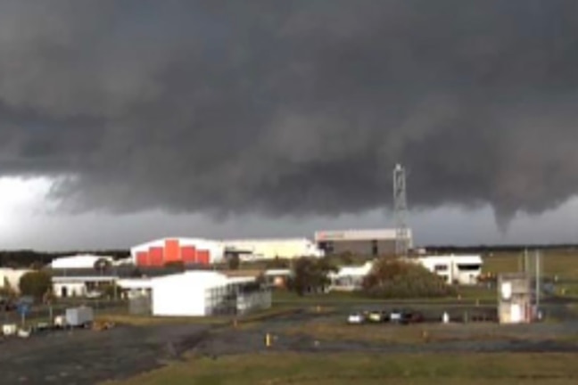 A tornado briefly touches down in a storm at Brisbane Airport. 