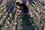 Girl plants US flags to commemorate September 11 attacks