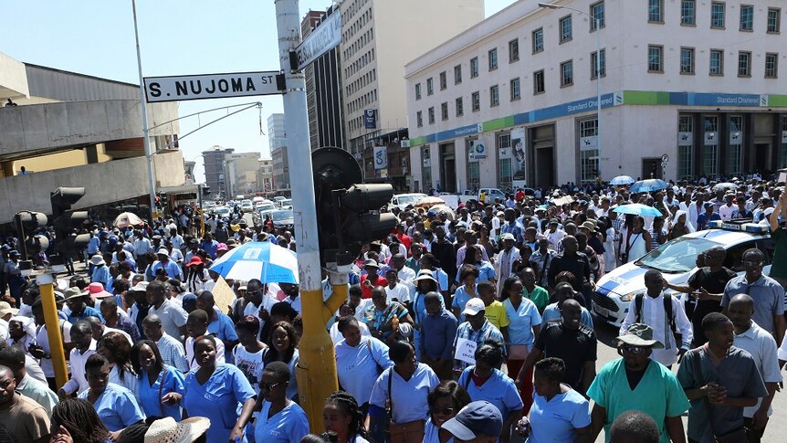 A large crowd of people striking on a street