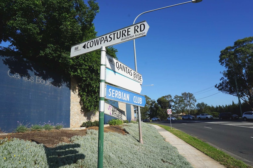 a sign along a major road which reads Cowpasture Road