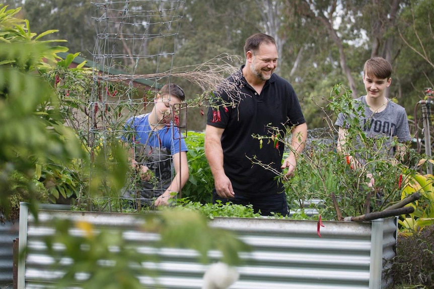 Father Mark Valencia at home in Bellmere, Queensland with sons James 14 and Luke 12 to depict a happy child parent relationship.