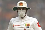 Sri Lanka's captain Dinesh Chandimal fields wearing an anti-pollution mask
