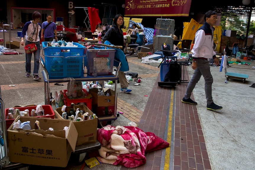 University staff members inspect the mess at campus of Polytechnic University in Hong Kong.