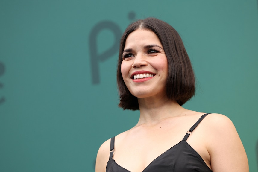 America Ferrera pictured from shoulders up, short bob, smiling