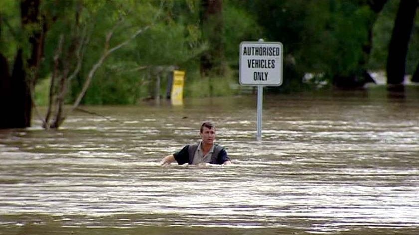 A man makes his way through floodwaters