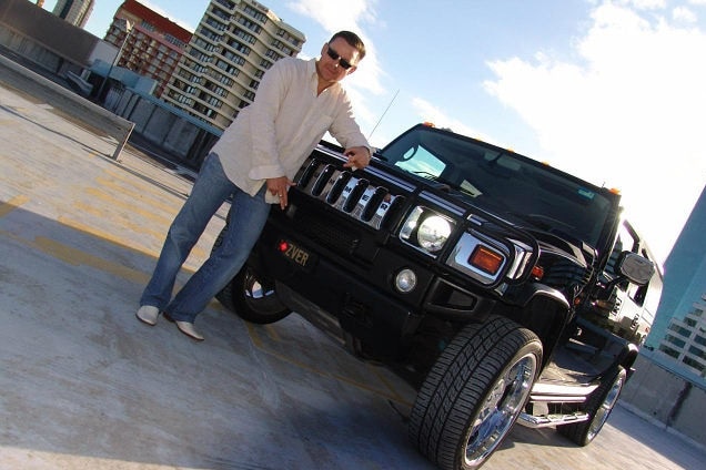 Vitali Roesch gestures while standing in front of a black Humme.