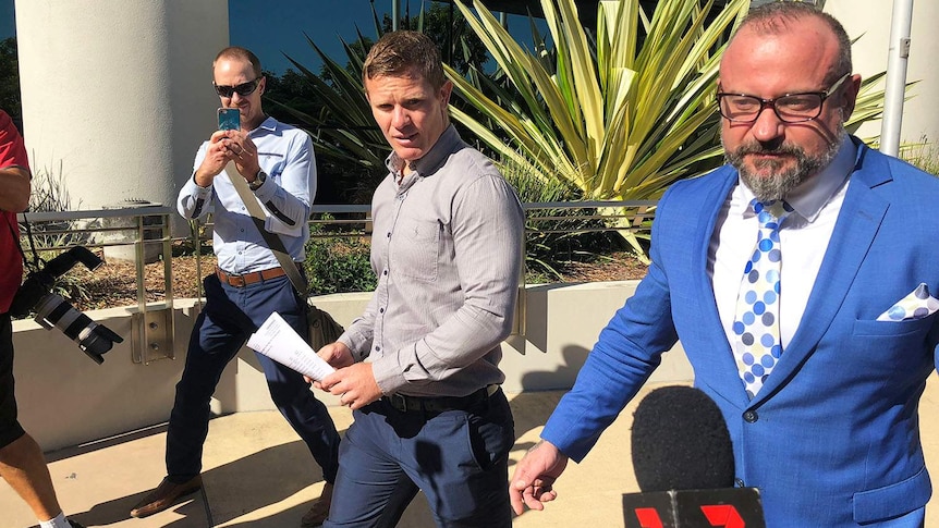 Former NRL player Steve Michaels leaves Southport court on Queensland's Gold Coast with his lawyer Campbell MacCallum.