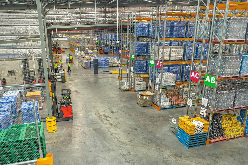 Interior of the Woolworths regional distribution centre in Townsville, a large warehouse which has shelves stacked with pallets