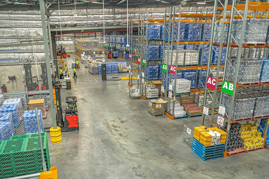 Interior of the Woolworths regional distribution centre in Townsville, a large warehouse which has shelves stacked with pallets