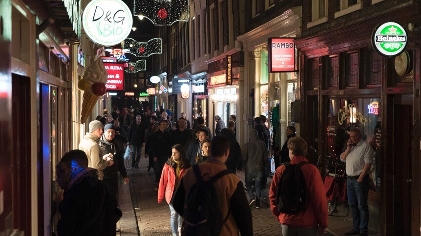 Night-time revellers fill the streets in Amsterdam's historic centre