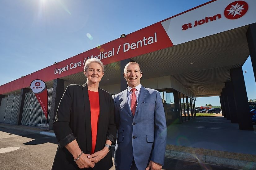 Michelle Fyfe and Antony Smithson wear professional attire as they stand outside an urgent care facility