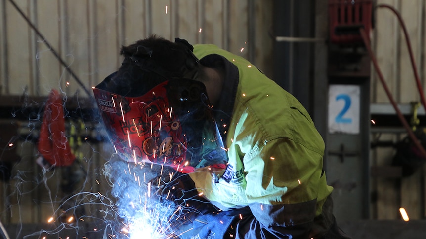 Worker uses welding equipment