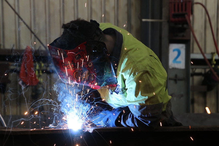 Worker uses welding equipment