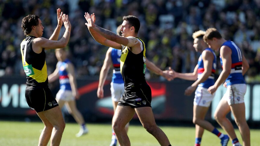 Jack Graham of the Tigers celebrates with Daniel Rioli in Richmond's win over Western Bulldogs.