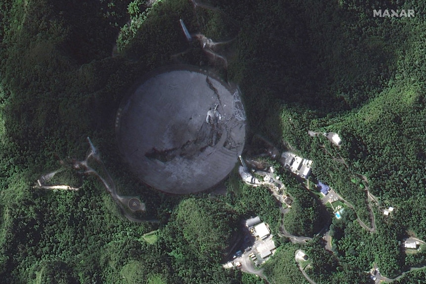 A satellite photo of the Arecibo Observatory's telescope after it collapsed