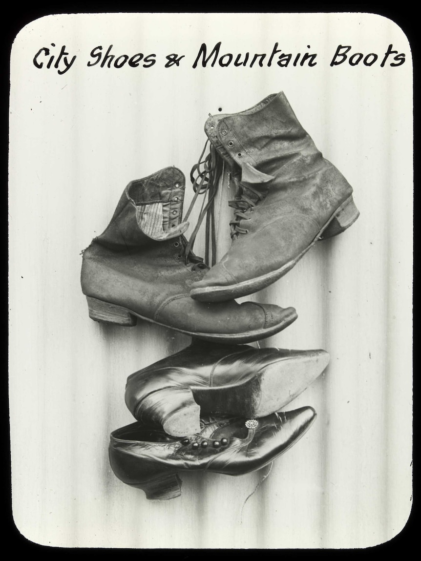 An image of city shoes and mountain boots juxtaposed. Black and white vintage.