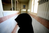 A female prison guard stands along a corridor in Tehran's Evin prison.