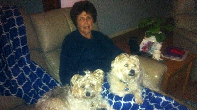 Carole Thomson on the couch with dogs