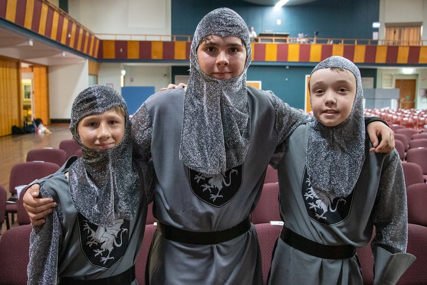 Three kids dressed as medieval guards, Longreach, November 2022.