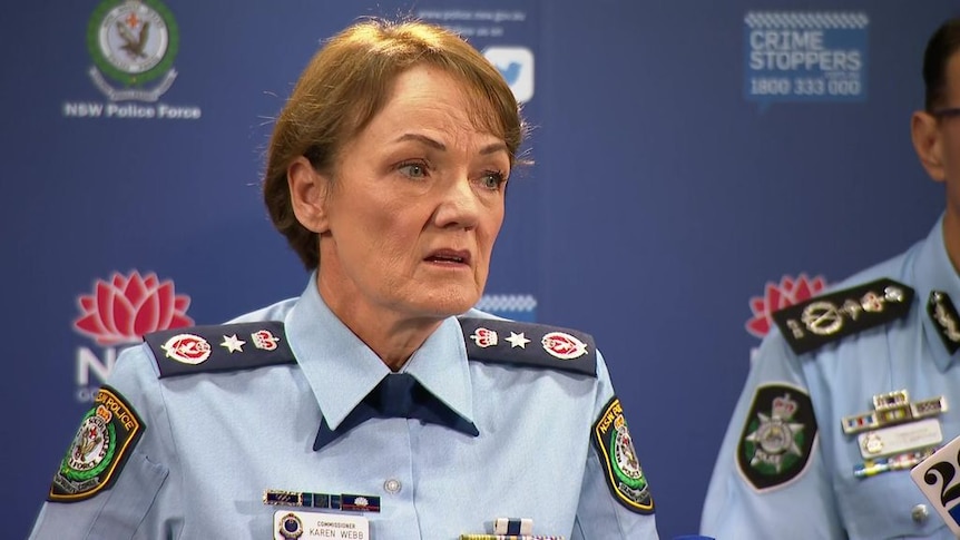 A female police officer speaks during a media conference.