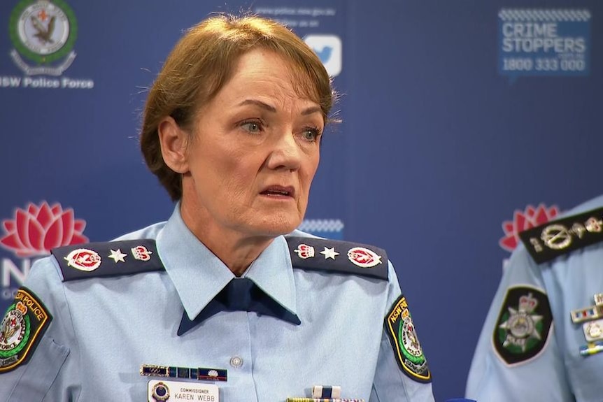 A female police officer speaks during a media conference.