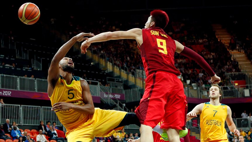China's Sun Yue (R) rejects a shot from Australia's Patrick Mills at the London 2012 Olympic Games.