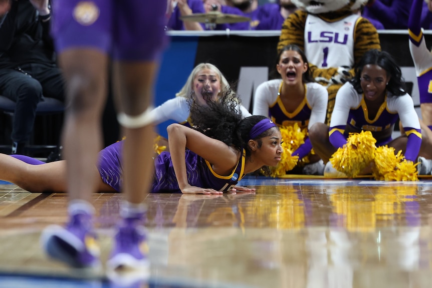 LSU basketball player Angel lies on her stomach on the floor during an NCAA tournament game.