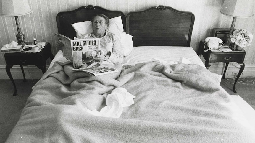 Malcolm Fraser in bed reading the newspaper after the 1980 election.