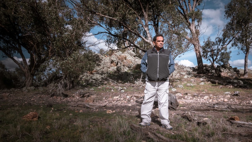 Aboriginal man James Ingram standing in bushland.