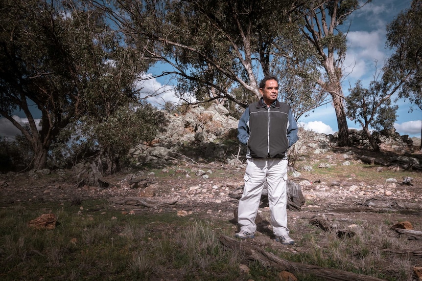 Aboriginal man James Ingram standing in bushland.