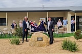 Senator Karen Grogan (holds an Australian flag with the Mayor of Kimba, Dean Johnson in front of the Kimba Medical Centre