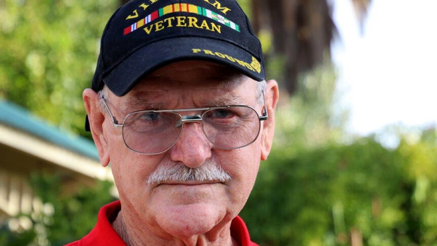 Headshot of a man wearing glasses and a hat that says Vietnam Veteran.