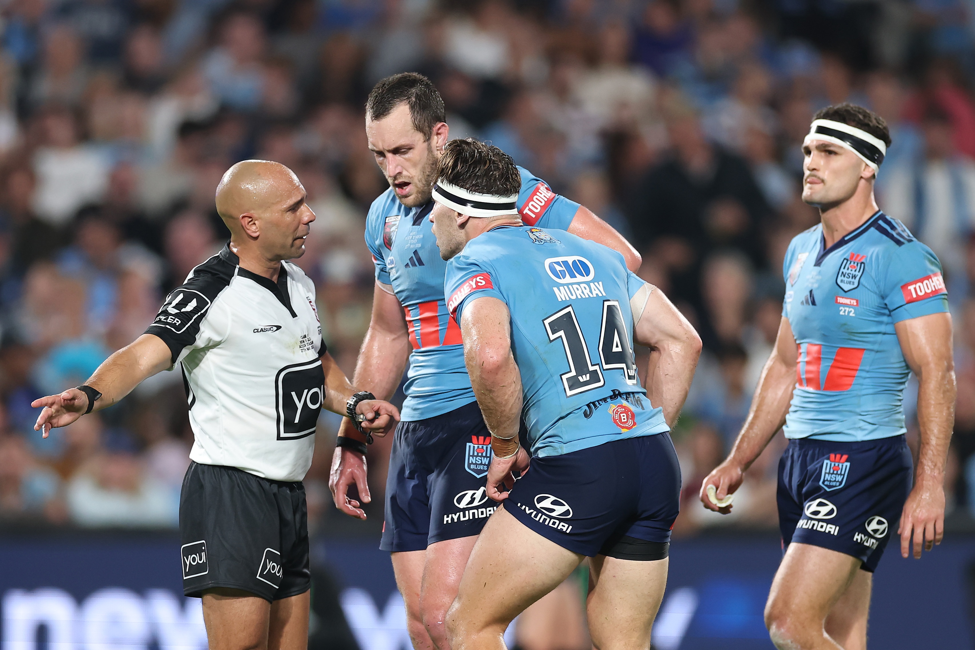 NSW Blues players argue with referee Ashley Klein.