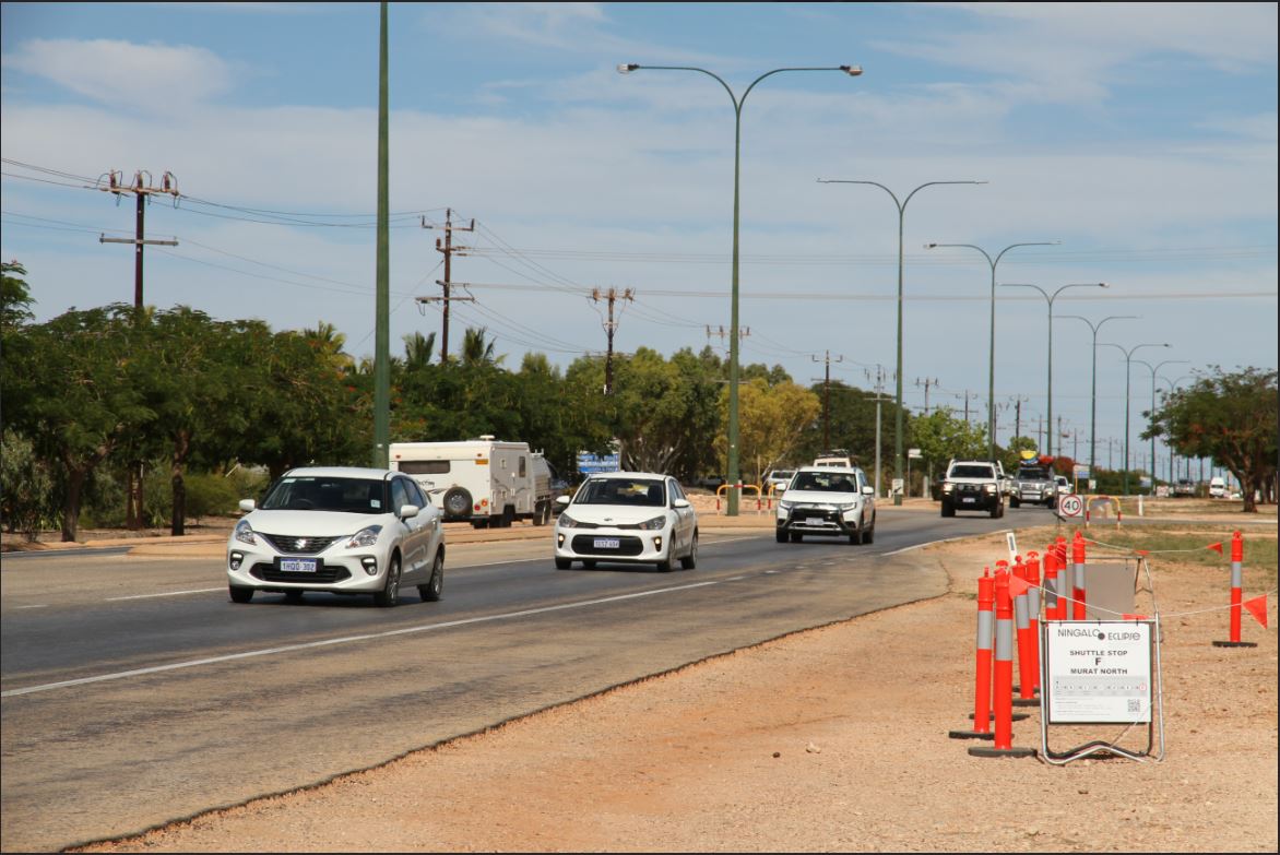 A line of cars travels along the road into Exmouth