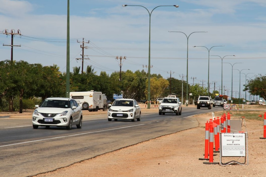 A line of cars travels along the road into Exmouth