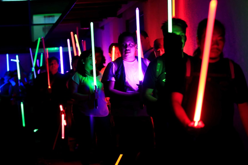 Star Wars enthusiasts raise lightsabers during Earth Hour