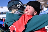 Tess Coady smiles while having a big hug with Emily Arthur