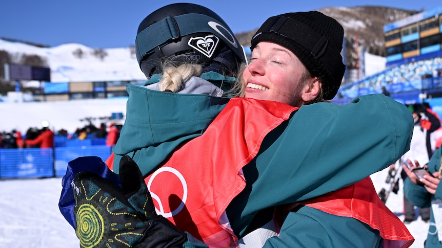 Tess Coady smiles while having a big hug with Emily Arthur