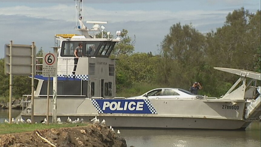 A Qld police barge returns from Macleay Island