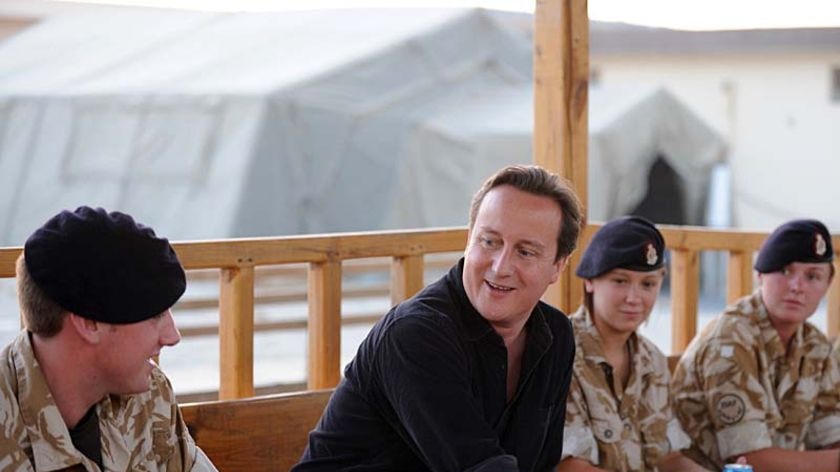British Prime Minister David Cameron speaks with troops in southern Afghanistan