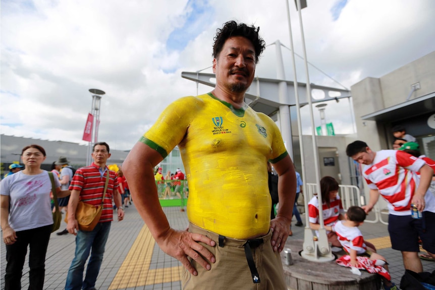 A male rugby union fan with a body-painted Wallabies jersey ahead of the Rugby World Cup match between Australia and Wales.