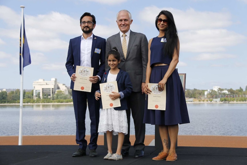 Sami Shah, Ishma Alvi and their daughter Anya Shah stand with Prime Minister Malcolm Turnbull at Citizenship ceremony.