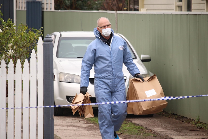Evidence from a crime scene in Ulverstone stabbing being removed by forensics.