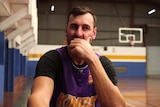 Andrew Bogut sitting with his chin resting in one hand