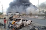 Burnt vehicle in Mosul after insurgent attacks